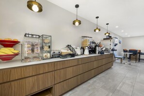 A modern kitchen with a wooden counter, various food items, and kitchen appliances. - Best Western San Diego Pacific Beach/mission Bay (San Diego)