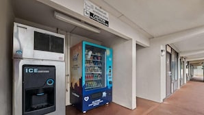 A hallway with a vending machine and an ice dispenser. - Americas Best Value Inn Orlando (Orlando)