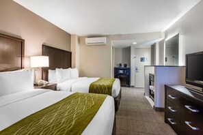 A hotel room with two beds, a TV, a dresser, and a bathroom visible through an open door. - Best Western Inn & Suites San Diego - Zoo/seaworld Area (San Diego)