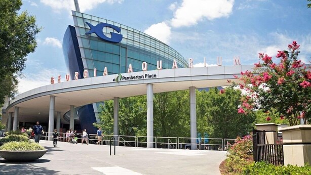 The exterior of the Georgia Aquarium at Pemberton Place, featuring a modern glass structure and a prominent 'G' logo. - Motel6 Atlanta, GA - Atlanta Airport East (Atlanta)