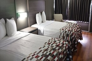 A hotel room with two beds, a nightstand, a chair, and a window with curtains. - Red Roof Inn Fort Worth West (Fort Worth)