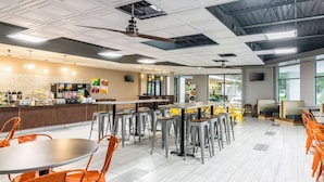 A modern cafeteria with high ceilings, a central serving area, and ample seating. - Rest and Relax Inn (Pensacola)