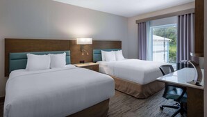 A hotel room with two beds, a desk, and a chair. - Tryp by Wyndham Tallahassee North I-10 Capital Cir (Tallahassee)