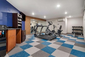 A gym with exercise equipment, a checkered floor, and a mirrored wall. - Tryp by Wyndham Tallahassee North I-10 Capital Cir (Tallahassee)