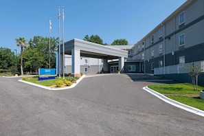 A building with a covered entrance, a sign reading 'TRYP,' and a parking lot. - Tryp by Wyndham Tallahassee North I-10 Capital Cir (Tallahassee)