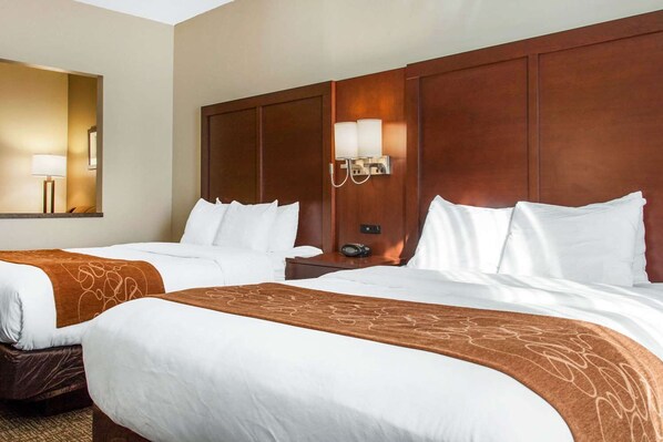 A hotel room with two beds, a large mirror, a nightstand with a lamp, and a wall-mounted light fixture. - Fairfield Inn & Suites by Marriott Scottsdale Old Town (Scottsdale)