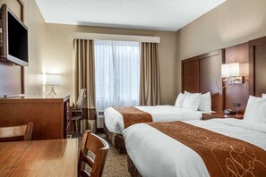 A hotel room with two beds, a desk, a TV, and a window with curtains. - Fairfield Inn & Suites by Marriott Scottsdale Old Town (Scottsdale)