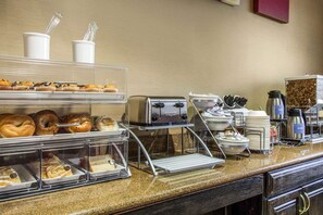 A breakfast buffet with various pastries, a toaster, and coffee-making equipment. - Fairfield Inn & Suites by Marriott Scottsdale Old Town (Scottsdale)