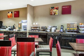 A breakfast area with seating, a coffee station, and a buffet with various food items. - Fairfield Inn & Suites by Marriott Scottsdale Old Town (Scottsdale)