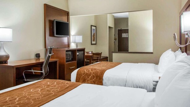 A hotel room with two beds, a desk, a TV, a chair, a microwave, and a mirror. - Fairfield Inn & Suites by Marriott Scottsdale Old Town (Scottsdale)