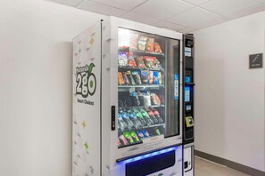 A vending machine with a variety of snacks and drinks, labeled 'Natuals 2GO Smart Choices.' - Comfort Inn & Suites Louisville Airport Fair & Expo (Louisville)