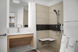 A modern bathroom with a shower, sink, and mirror. - Towneplace Suites by Marriott Birmingham South (Birmingham)