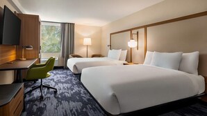 A hotel room with two beds, a desk with a chair, a TV, and a window with curtains. - Hotel Monona (Madison)