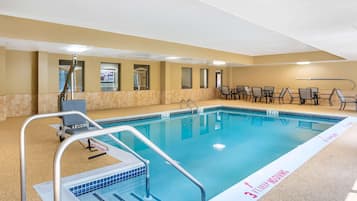 A swimming pool with a 3 ft deep diving area, surrounded by chairs and tables.