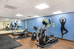 A gym with treadmills, stationary bikes, and a wall with fitness-related graphics. - Best Western Grantville/hershey (Grantville)