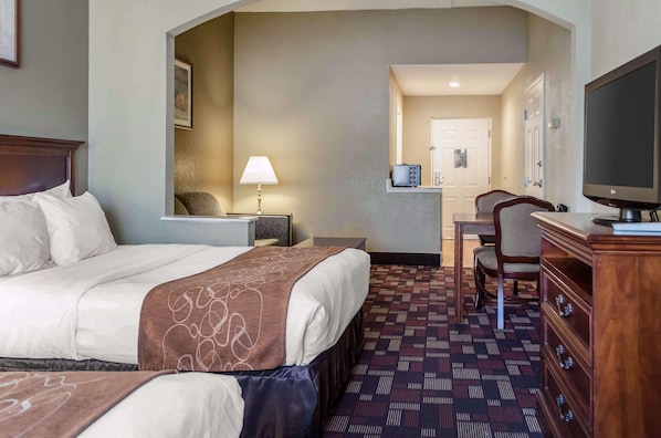 A hotel room with a bed, a desk, a chair, a television, and a door. - Best Western Grantville/hershey (Grantville)