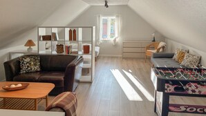 A cozy loft-style room with a loft bed, a sofa, a coffee table, and a foosball table. - Amazing home in Assens with house sea view (Assens)