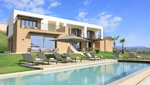 A modern resort with a swimming pool, sun loungers, and a view of the mountains. - Rocco Forte Private Villas (Sciacca)