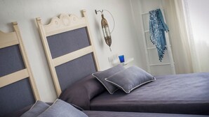 A bedroom with two beds, each with a headboard and pillows. - Mari Del Sud Resort, Vulcano (Lipari)