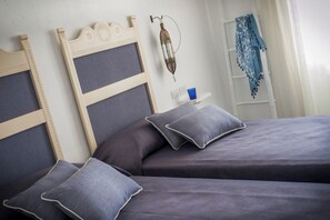 A bedroom with two beds, each with a headboard and pillows. - Mari Del Sud Resort, Vulcano (Lipari)