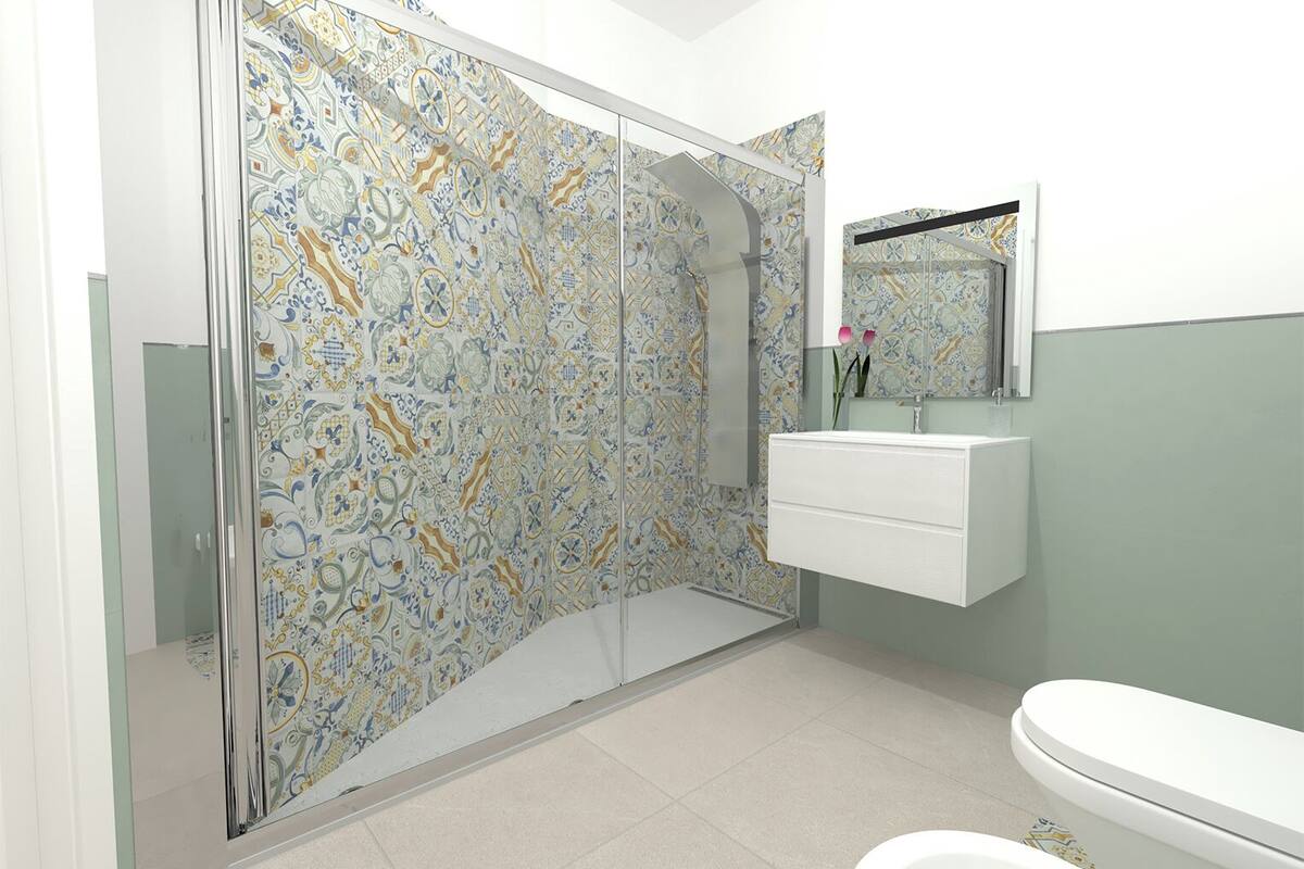 Une salle de bain avec une douche, un lavabo et des toilettes.
