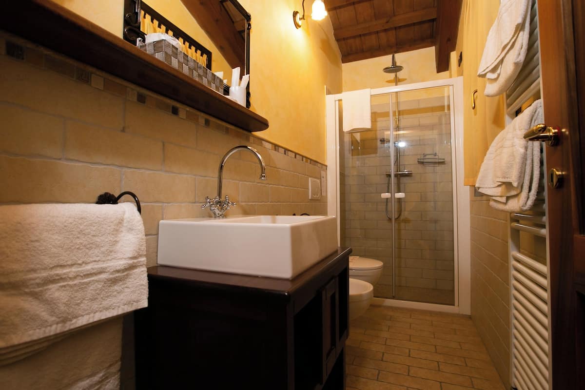 A bathroom with a sink, toilet, and shower.