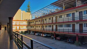 A multi-story parking garage with several cars parked. - Hotel Mesón del Bosque  (Querétaro)