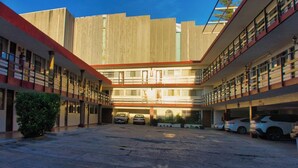A multi-story parking garage with several cars parked. - Hotel Mesón del Bosque  (Querétaro)