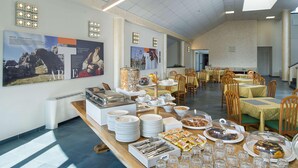 A buffet setup with various food items and dining tables. - Testani Colleferro (Colleferro)