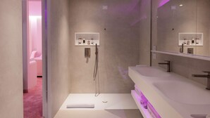 A modern bathroom with a walk-in shower, a large mirror, and a dual sink vanity. - Odsweet Duomo Milano Hotel (Milan)