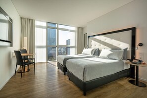 A modern hotel room with a large bed, a desk, and a chair. - Innside Milano Torre Galfa (Milan)