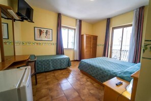 A room with two beds, a desk, a chair, a TV, and a window with curtains. - Hotel San Pietro Beach - Letojanni (Letojanni)