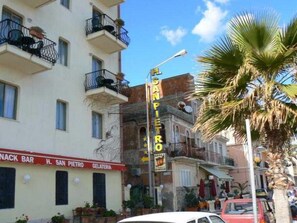 A street view with a building labeled "H. San Pietro Gelateria" and a sign for "San Pietro". - Hotel San Pietro Beach - Letojanni (Letojanni)