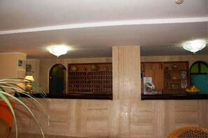 A room with a wooden ceiling, a large central column, and a counter with various items. - Hotel San Pietro Beach - Letojanni (Letojanni)
