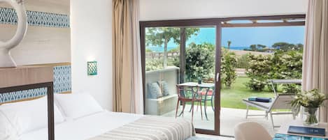 A hotel room with a bed, a desk, and a view of the outdoors.