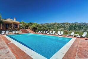 A swimming pool with white lounge chairs and a stone building in the background. - Agriturismo Il Poggio Luxury Country Resort (Graniti)