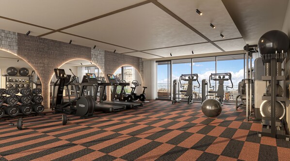 A modern gym with cardio machines, free weights, and a large window offering a city view. - Hyatt Regency Rome Central (Rome)