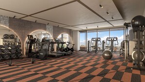 A modern gym with cardio machines, free weights, and a large window offering a city view.