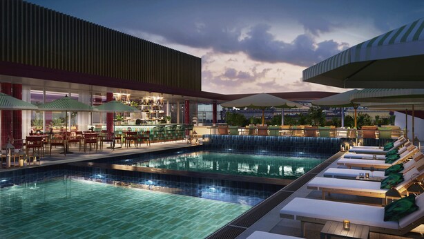 A pool area with lounge chairs and umbrellas, a bar with a view, and a waterfall feature. - Hyatt Regency Rome Central (Rome)