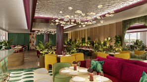 A modern restaurant interior with round tables, green and yellow chairs, and a vibrant ceiling design. - Hyatt Regency Rome Central (Rome)