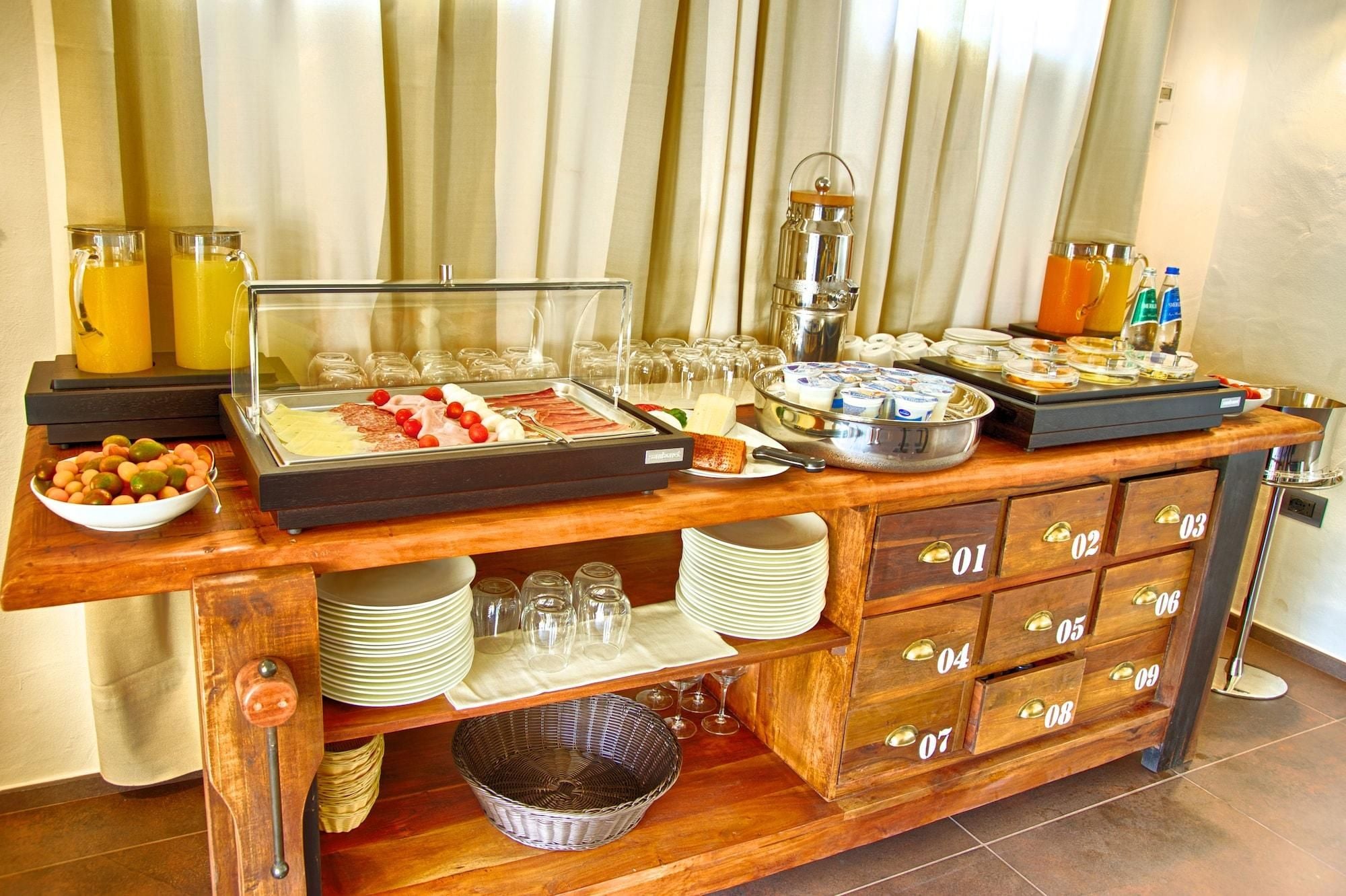A buffet setup with various food items, a fruit bowl, and a beverage station.