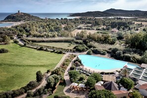 A large swimming pool surrounded by lush greenery and a view of the sea. - Veridia Resort, a Member of Radisson Individuals (Domus de Maria)