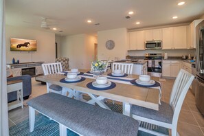 A modern kitchen with white cabinets, a microwave, and a refrigerator. - Escape the Winter! Cozy 3BR Retreat in Sunny Ocala, Florida (Ocala)