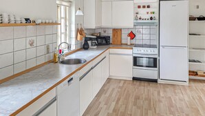 A kitchen with white cabinets, a dishwasher, a stove, and a refrigerator. - Amazing home in Farsø with house a panoramic view (Farsø)