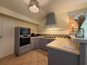 A kitchen with a built-in oven, a stove, a sink, and a countertop. - BIXTA EDER - MACAYE - B&B (MACAYE)