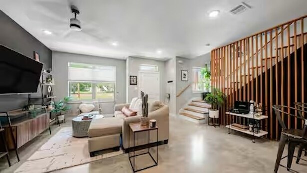 A modern living room with a sofa, coffee table, and TV. - The Hard Rock Condo! (Bryan)