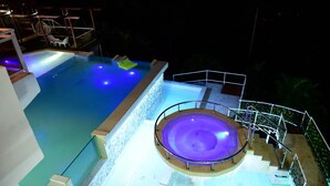 A swimming pool with a hot tub, surrounded by a white railing and a staircase leading down. - Paradise  villa (Pedro Brand)