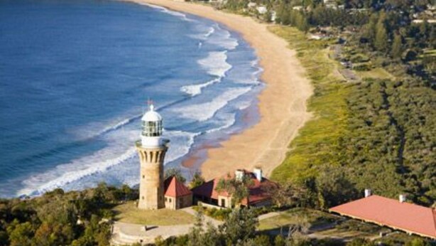 A coastal area with a lighthouse, beach, and residential buildings. - Stay and Float in Basin Bliss (Saint Georges Basin)