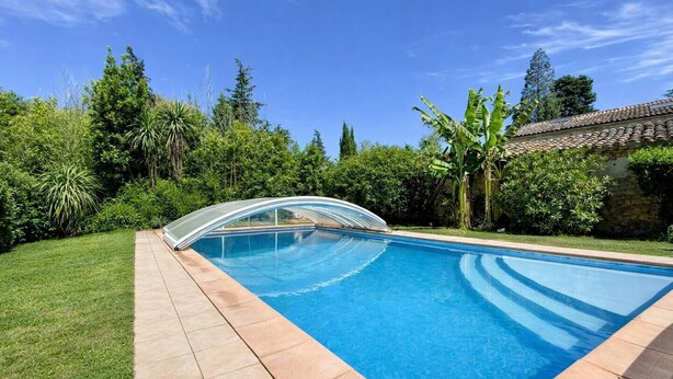 A rectangular swimming pool with a clear blue water surface, surrounded by a tiled deck and lush greenery. - Le Souleilla - SAINT JULIEN DE BRIOLA (SAINT JULIEN DE BRIOLA)
