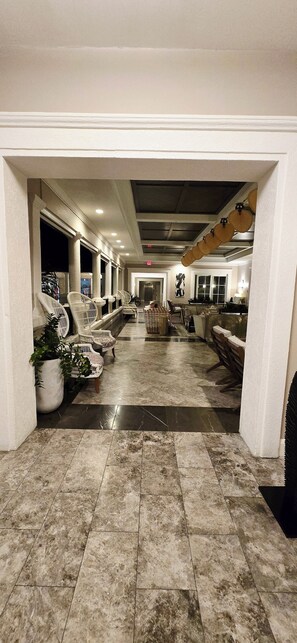 A hotel lobby with a marble floor, white walls, and a central seating area with sofas and chairs. - Oceanfront Ritz-Carlton Condo 2BR 2.5BA, Full Resort Amenities! (St Thomas)